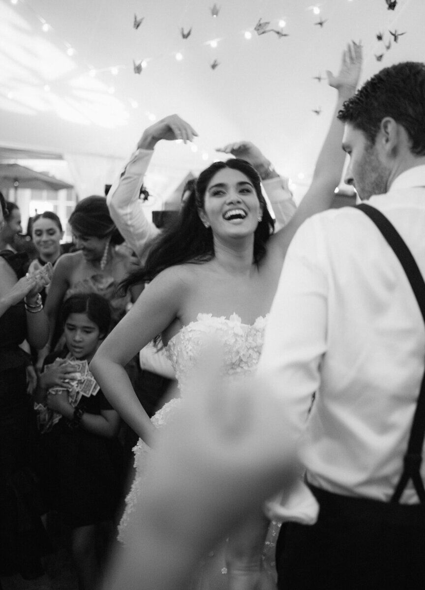 A bride and her guests dance during the lively reception at her waterfront wedding.
