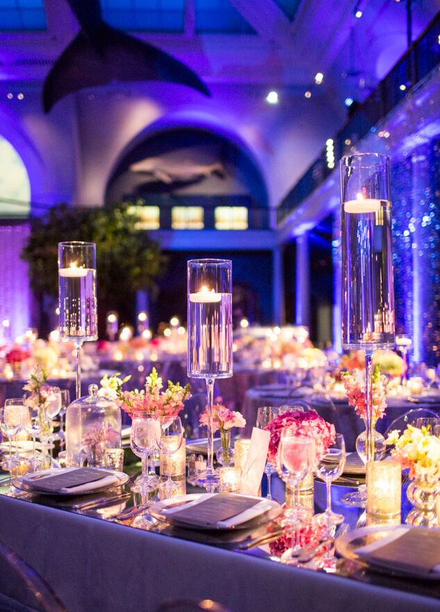 Wedding budget: Glowy blue and pink ballroom wedding reception tablescape with votive candles