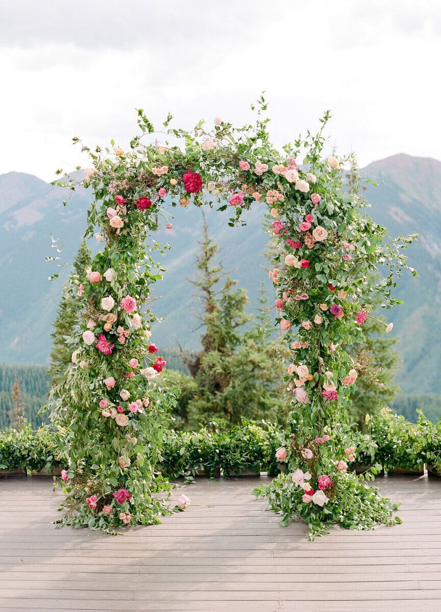 Wedding budget: Gorgeous green and pink floral wedding arch overlooking the mountains of Aspen