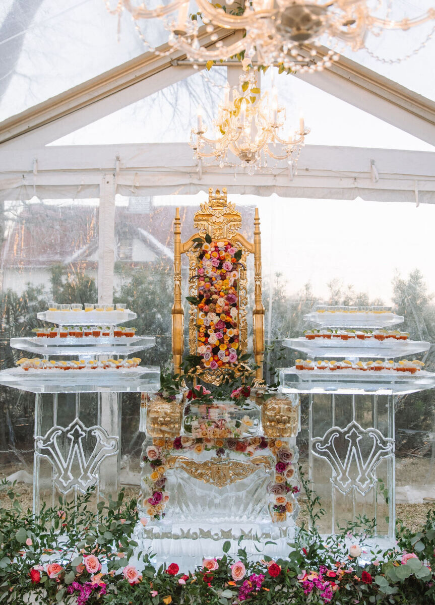 An ornate ice sculpture in the form of a throne serves as a food display during a Texas wedding reception.