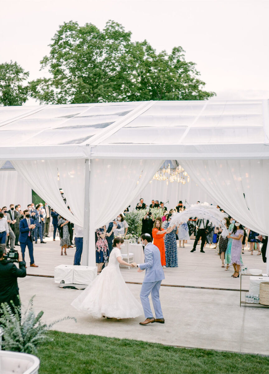 Wedding details: Noa and Adin dancing outside of their open air wedding reception tent