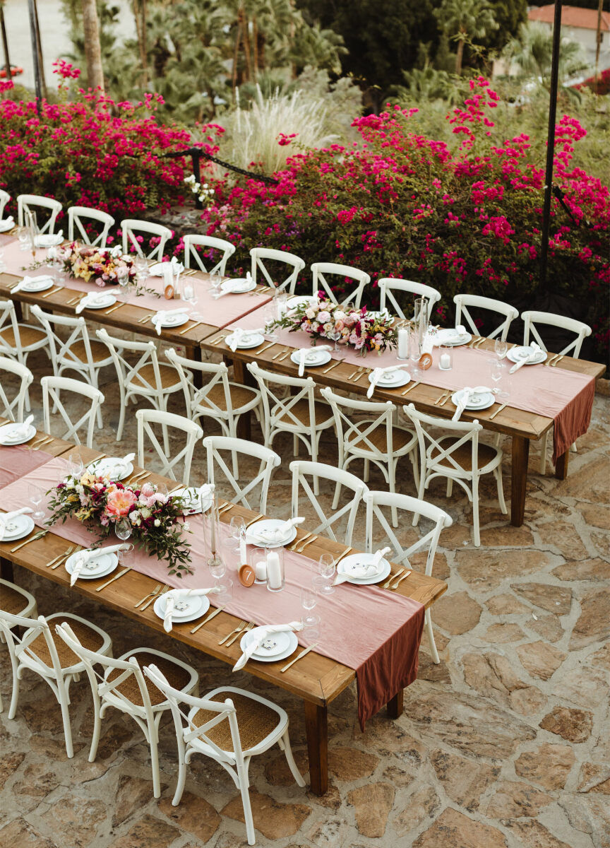 Wedding Etiquette Budget: Two long rectangular reception tables on a stone patio at a wedding in Palm Springs, California.