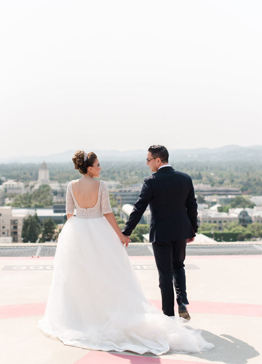 Wedding Photography Ideas: A wedding couple smiling at each other on a rooftop in Los Angeles.