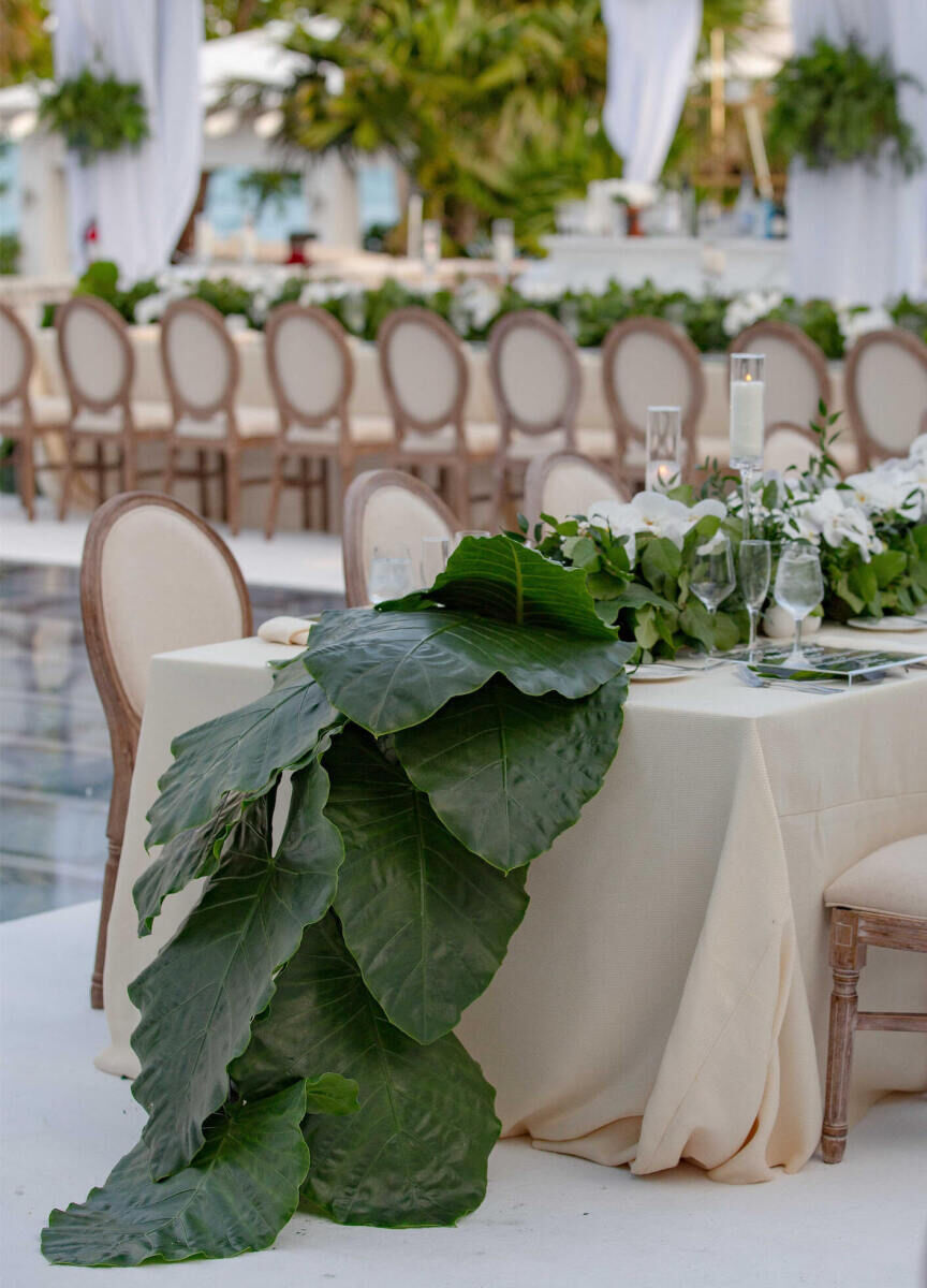 Wedding Photography Ideas: An oversize leaf table runner on a table with a cream-colored tablecloth and.