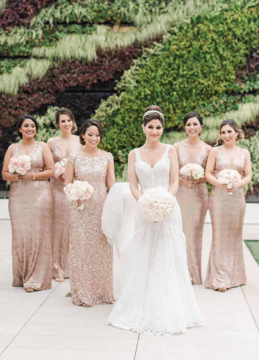 Wedding Photography Ideas: A bride posing for a portrait with her six bridesmaids, all of whom are wearing gold sequined dresses and holding white bouquets.