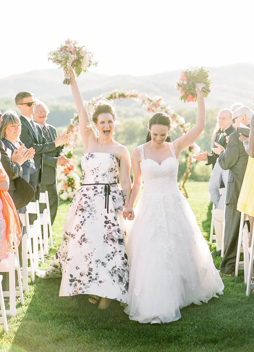 Wedding Tips: Two brides holding up their bouquets and smiling at an outdoor vineyard wedding in Virginia.
