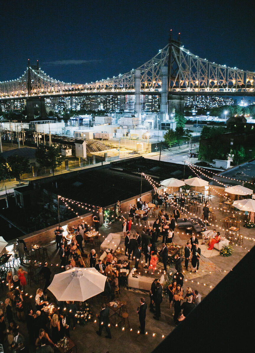 Wedding Tips: An overhead night shot of a city wedding venue with a NewYork bridge and skyline in the background.