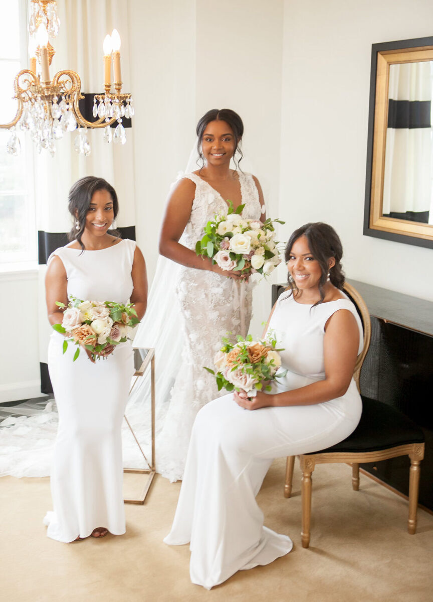 Wedding Tips: A bride with two bridesmaids smiling and posing for a photo.