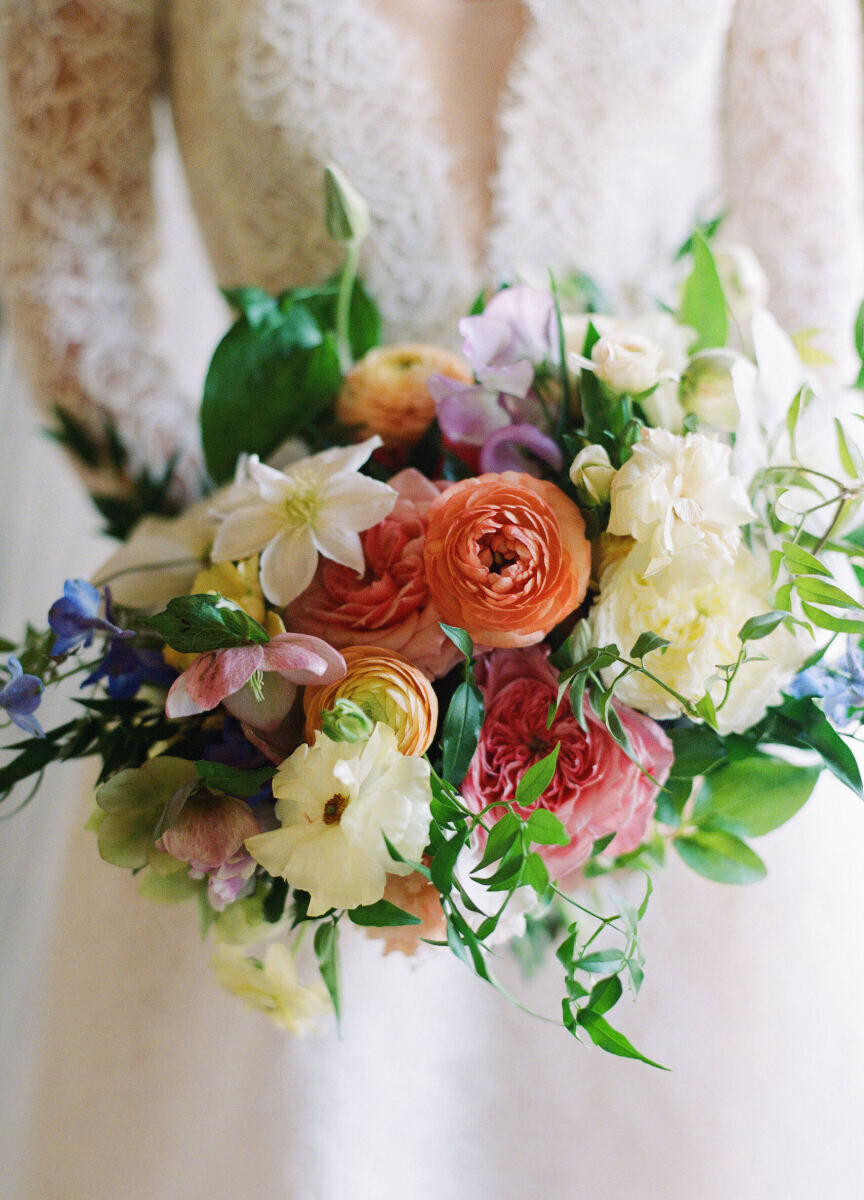 Wedding Tips: A close-up photo of a bride holding her bouquet, which is filled with an array of colorful blooms.
