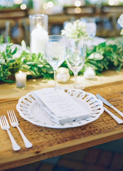 Wedding Tips: A dinner place setting with a menu on top of the plate at a wedding reception.