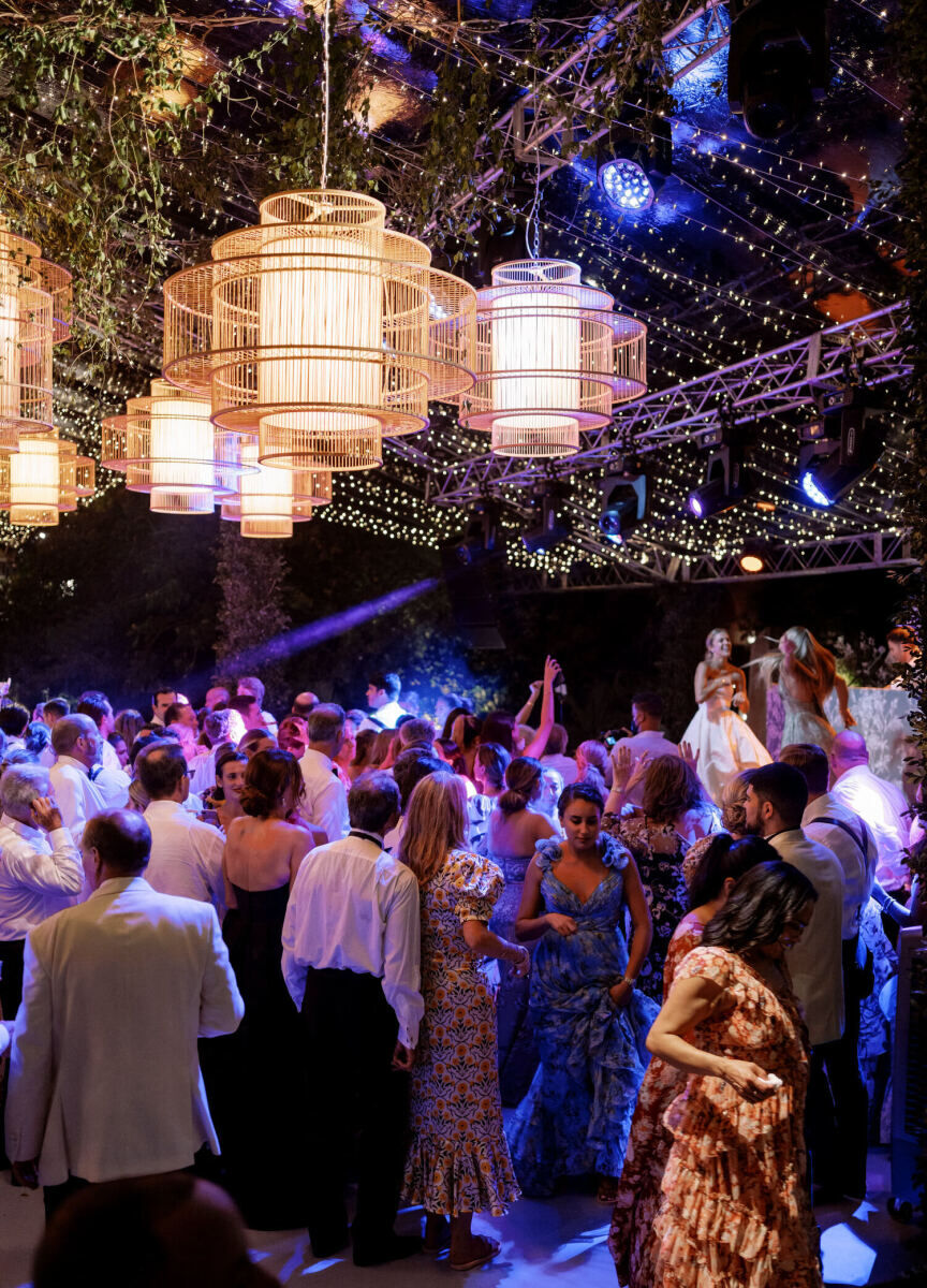 Wedding Tips: A packed dance floor at a lit-up reception with lights hanging overhead.