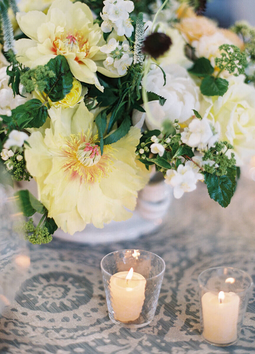Wedding Website Examples: A yellow, white and green floral arrangement at a wedding reception in Virginia.