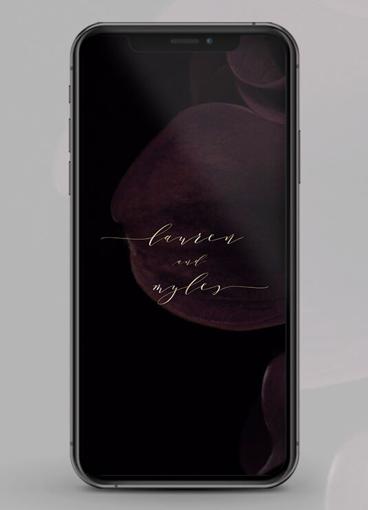 Wedding Website Examples: A mobile display showing a wedding website with subtle dark floral accents.