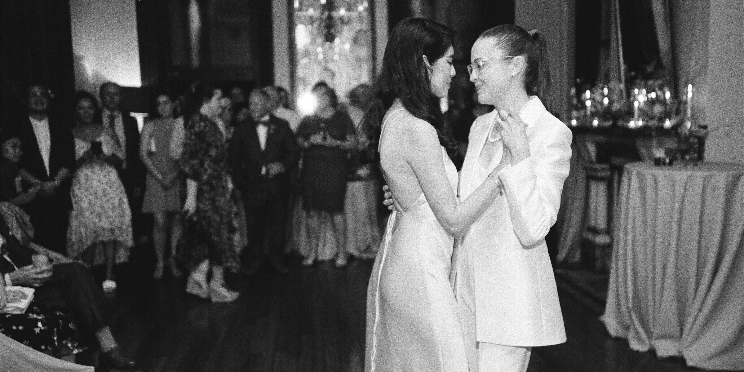 Brides share a first dance during their whimsical wedding reception in New Orleans, Louisiana.