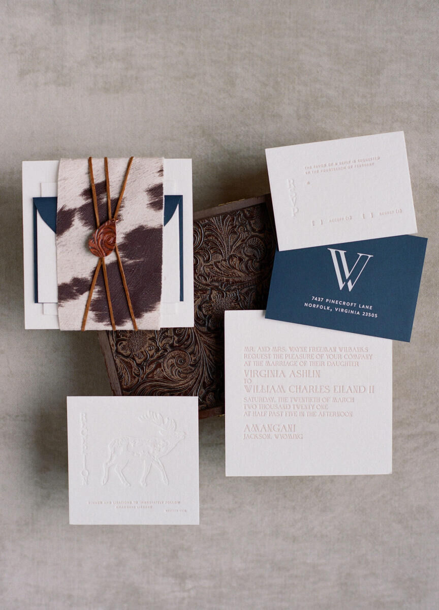 Winter wedding details: A letter-pressed wedding invitation suite featuring a monogram, moose illustration, and hide detail.