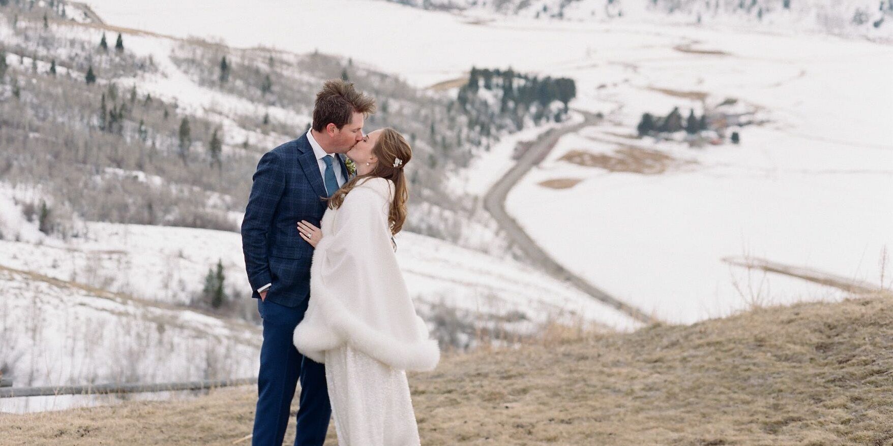 Winter wedding details: A bride and groom embrace before their winter wedding ceremony in Wyoming.