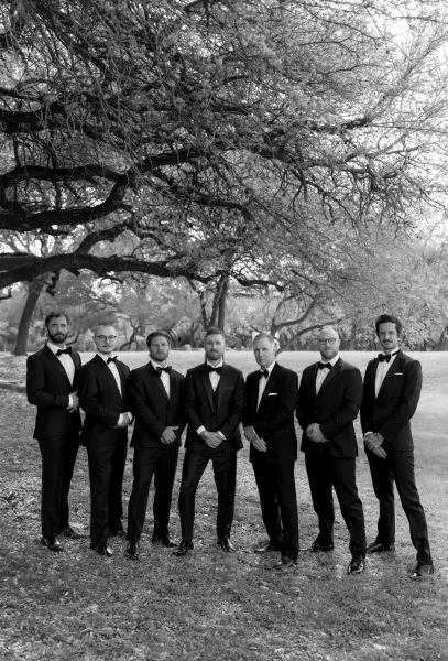 Groomsmen portrait featuring the groom with groomsmen, a polished lineup in classic tuxedos, unified and relaxed for a timeless look