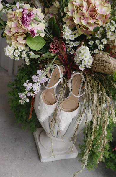 Bridal shoes, white slingback bridal heels framed by hydrangeas for a soft, garden-inspired feel and feminine touch.
