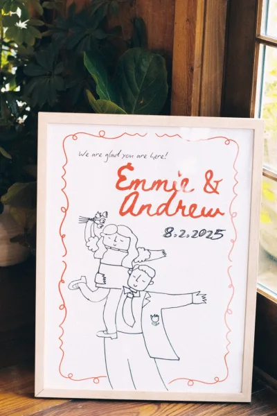 Wedding welcome sign, custom wedding welcome sign with hand lettering and illustrated couple drawing in a red border against a wooden wall