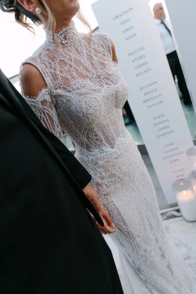 Wedding dress close-up of a lace wedding dress, with delicate pearl earrings adding a soft shimmer to the refined bridal detail.