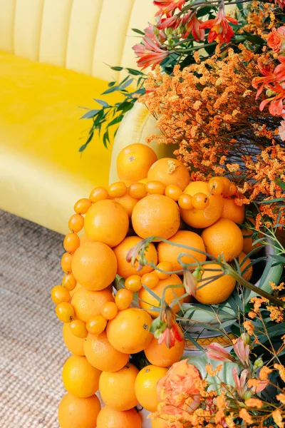 Citrus wedding decor defines the reception lounge decor, highlighted by a bold yellow sofa for a cheerful, modern spot to gather.
