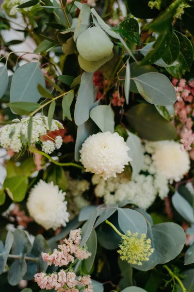 Wedding flowers featuring eucalyptus, a lush green-and-white arrangement with loose, organic styling and soft texture