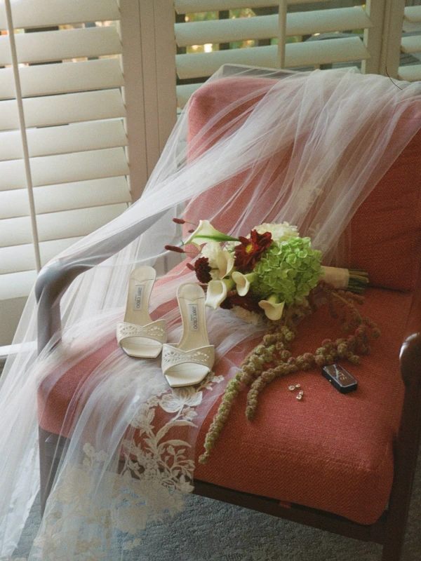A Burgundy and Green Wedding Draped Between Old Plaster and Weathered Wood