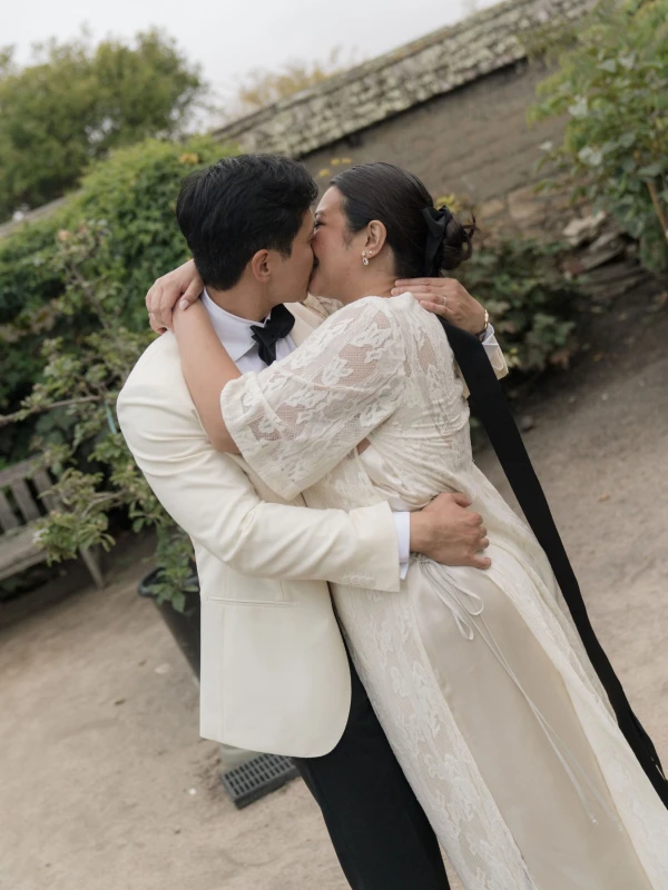 A Burgundy and Green Wedding Draped Between Old Plaster and Weathered Wood