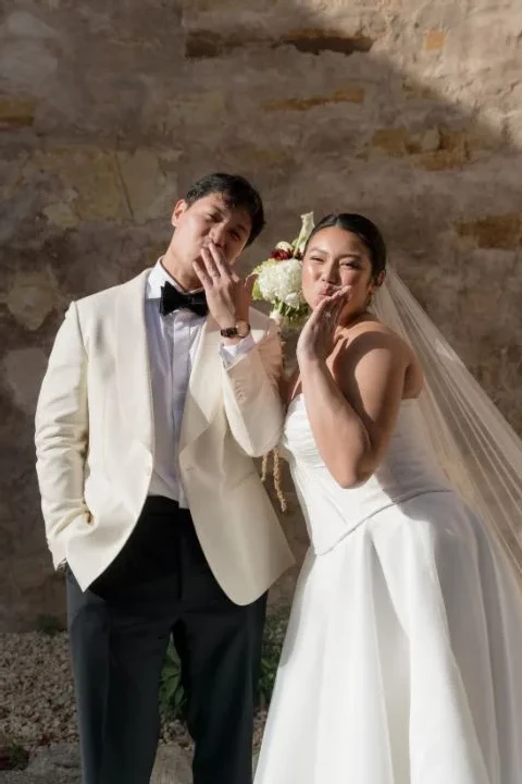 A Burgundy and Green Wedding Draped Between Old Plaster and Weathered Wood